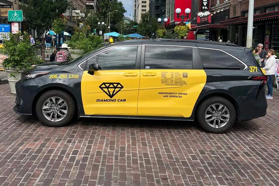 Cab 371 in profile on a brick pedestrian street in downtown Seattle.